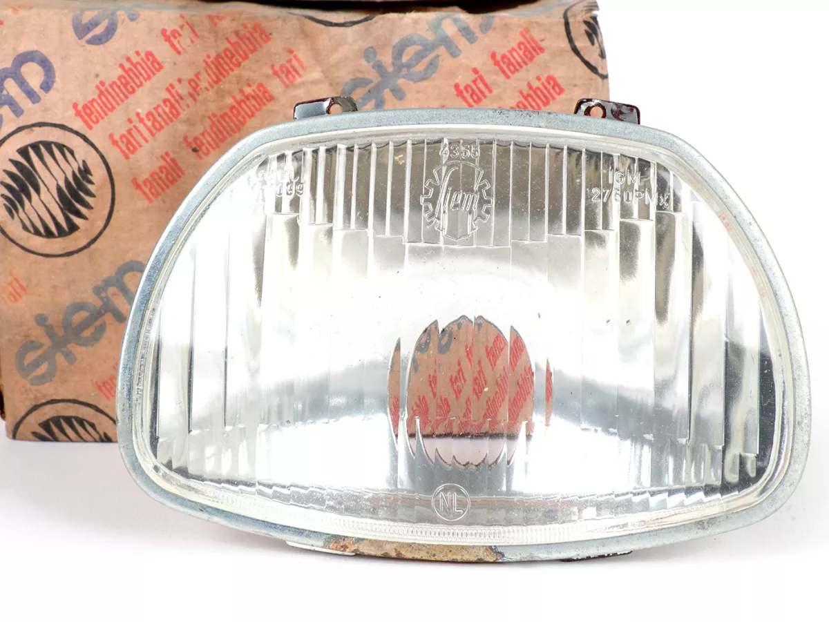 Koplamp -SIEM (NOS) trapezium - Vespa APE AD1, AE, AP ook geschikt voor Sprint150 (VLB1T), GL150 (VLA1T), GT125 (VNL2T), SS180 (VSC1T) - glas, incl. sierring, zonder koplampstekker